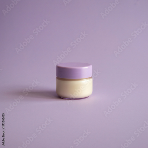 Purple cream jar on purple background