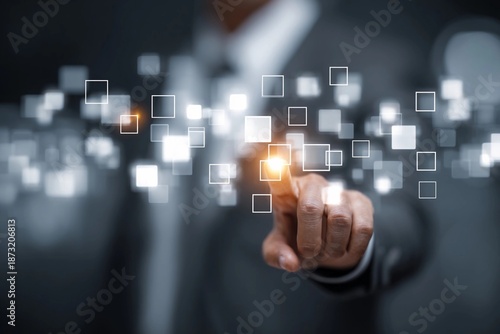 Man using touch screen technology in a business setting to interact with digital data squares
