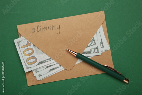 Envelope with word Alimony and money on green background.