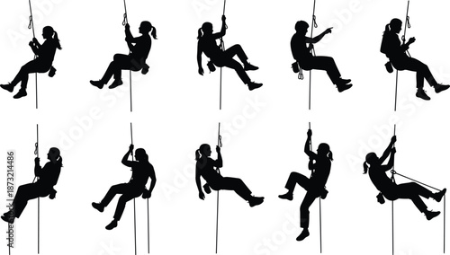 Silhouette young adults practicing rope climbing and rappelling with safety training during adventure activity at indoor gym sport challenge teamwork