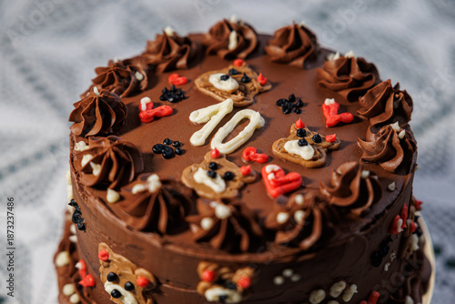 Wallpaper Mural Rich chocolate cake with piped buttercream, teddy bear motifs, hearts, and a bold number ten, displayed on a lace-covered table as a festive celebration centerpiece Torontodigital.ca