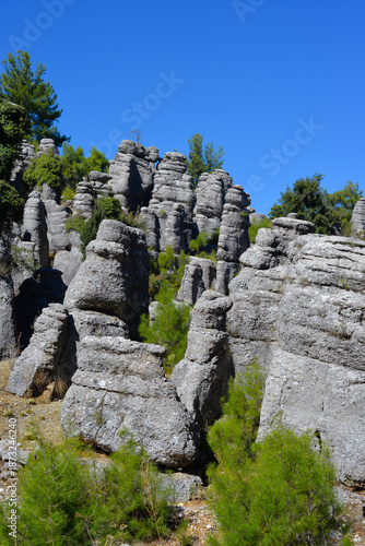 Majestic view of the valley with beautiful rock formations on an autumn day. They look like several standing men, so people called them 