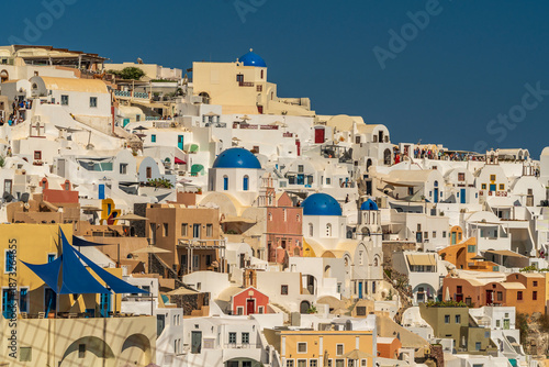 Panoramic View of Santorini Village with Blue Domes and White Houses
