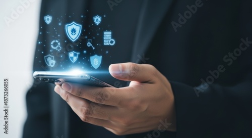 Wallpaper Mural Cybersecurity Technology: Man Holding Smartphone Displaying Security Icons, Data Encryption and Digital Protection Concepts Torontodigital.ca