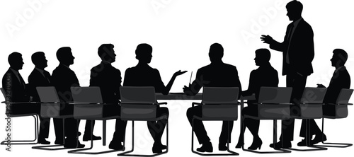 Silhouette of business people in a meeting around a table with a laptop conference