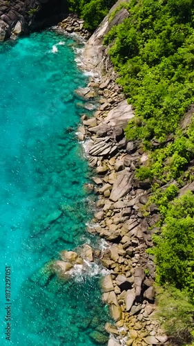 Wallpaper Mural Clear turquoise water stretches along the rocky coastline with lush green vegetation. Seychelles, Mahe. Torontodigital.ca