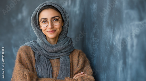 Happy Young Adult Woman in Headscarf and Glasses: Confident Portrait Showcasing Diverse Fashion and Identity in a Stylish Modern Studio Setting