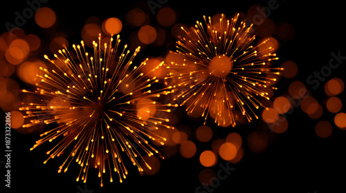 Vibrant orange fireworks exploding in dark night sky with bokeh lights