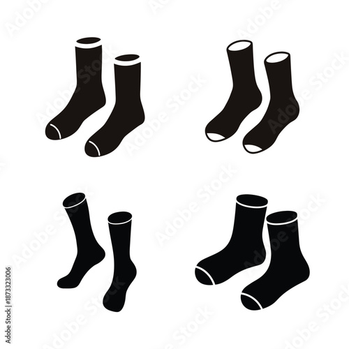 Collection of four pairs of plain black socks with white accents, ready for everyday wear