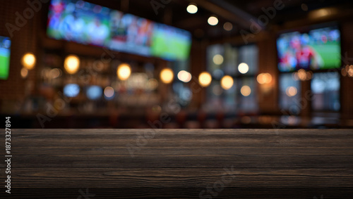 Fotografie Wooden tabletop and blurred abstract background of a sports bar with screens and