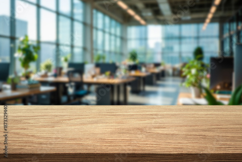 Wallpaper Mural wooden tabletop in the foreground and blurred spacious office with workstations Torontodigital.ca