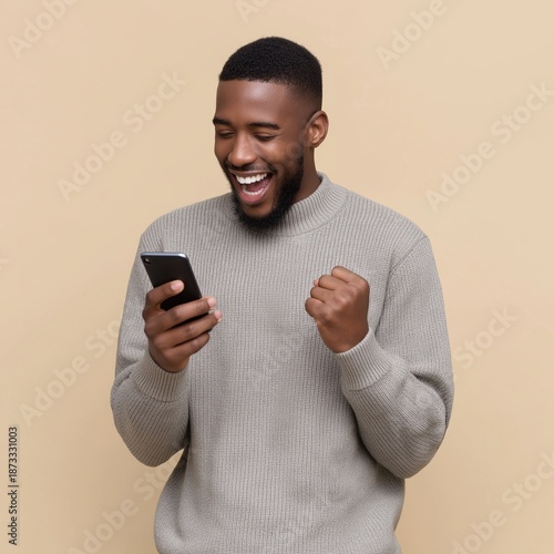 Excited man celebrating good news while looking at smartphone