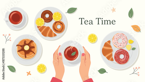 Top view of tea time with hands holding a cup of tea surrounded by pancakes donuts croissants and lemon slices on plates.
