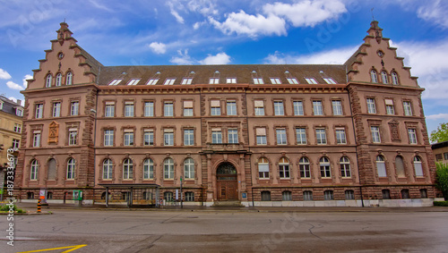 Front view of the historic Gewerbemuseum Basel showing symmetrical architecture, stone facade, and classic urban design.