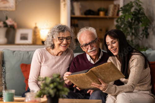 Senior Parents Reading Book With There Daughter