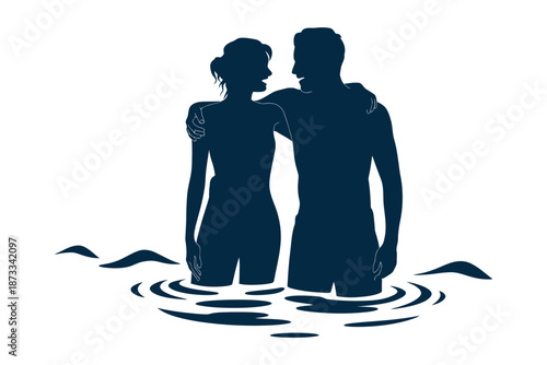 A romantic couple standing together in the water in silhouette