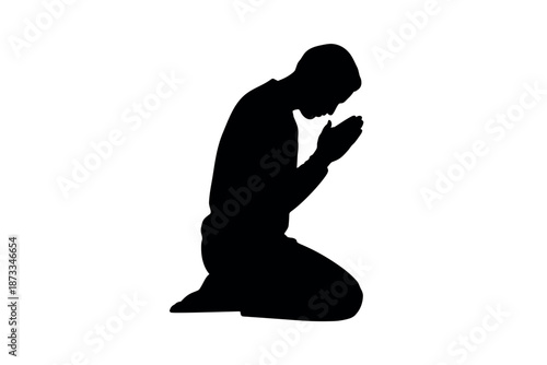 A man in prayer, kneeling in a moment of contemplation and devotion.