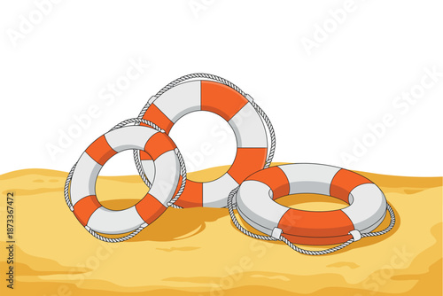 Three orange and white life preservers on a sandy beach shore