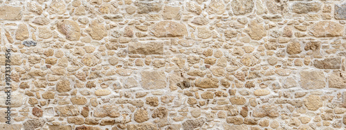 Old stone wall texture background showing masonry construction