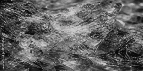Abstract texture of cold water drops splashing on a gray metal surface and window glass amidst a winter landscape of ice and stone