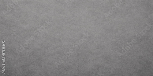 A rough grey paper texture with an aged grunge pattern on a blank vintage surface creates a dirty cardboard backdrop for a textured wall design