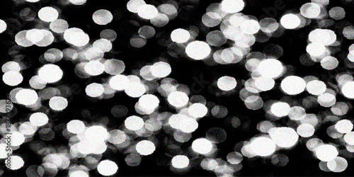 An abstract holiday bokeh background features glowing gold and blue defocused Christmas lights with shiny glitter circles and a bright blurred celebration glow for a festive night design