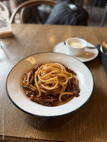 Classic Italian spaghetti with rich meat sauce on restaurant table