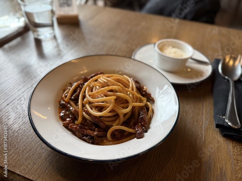 Classic Italian spaghetti with rich meat sauce on restaurant table