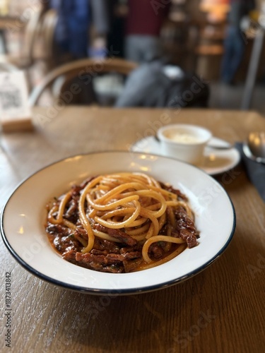 Classic Italian spaghetti with rich meat sauce on restaurant table