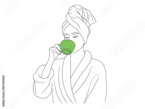 A woman in a bathrobe and towel on her head drinking from a green cup