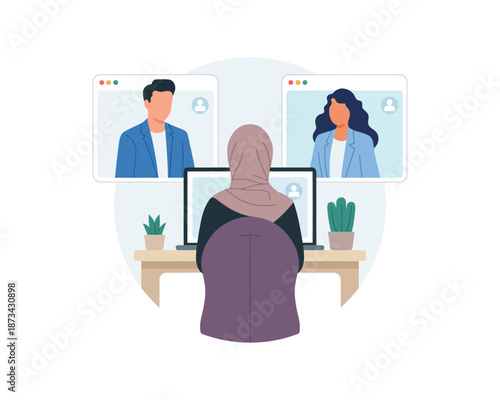 A woman wearing a hijab sits at a desk with two computer monitors, participating in a video conference with two colleagues.