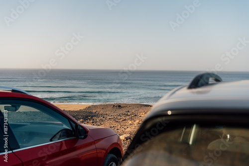 Parked cars facing the ocean at Cofete beach, Fuerteventura island