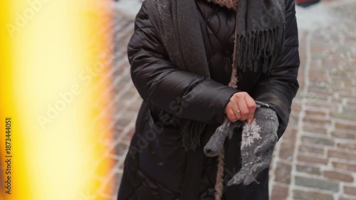Wallpaper Mural Solitary figure in dark clothing carrying umbrella navigating slick historical street during winter weather Torontodigital.ca