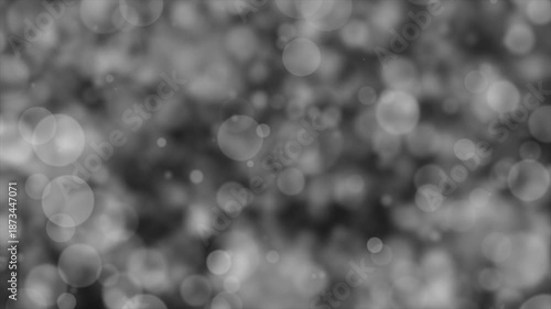Soft monochrome bokeh light particles on a dark gray background. Clean abstract backdrop with smooth blur and depth