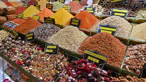 Istanbul, turkey, august 1, 2025. Large variety of vibrant spices, herbs, nuts, and teas arranged in heaps at a traditional market stall in istanbul, turkey