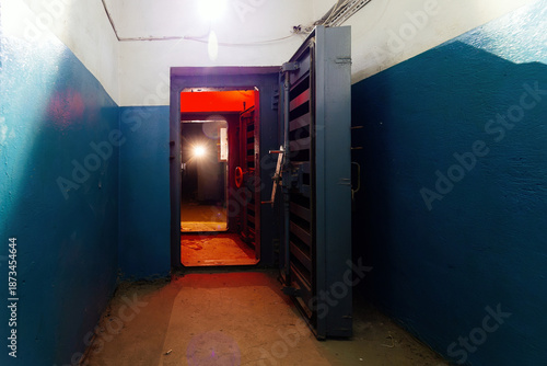 Entrance to bomb shelter protective construction of civil defense. Large armored blast proof iron door with valve