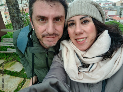 Portrait of a couple for husband and wife visiting a public park. The man and woman are about forty years old and of Italian origin