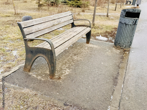 Abandoned Park Furniture And Litter, Rusty Benches And Empty Pathways Depict Neglect, An Overcast Morning Reveals Solitary Metal Bench With Chipped Paint And Litter Scattered Nearby