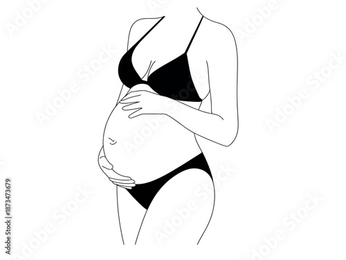 A pregnant woman in black lingerie cradling her belly with both hands