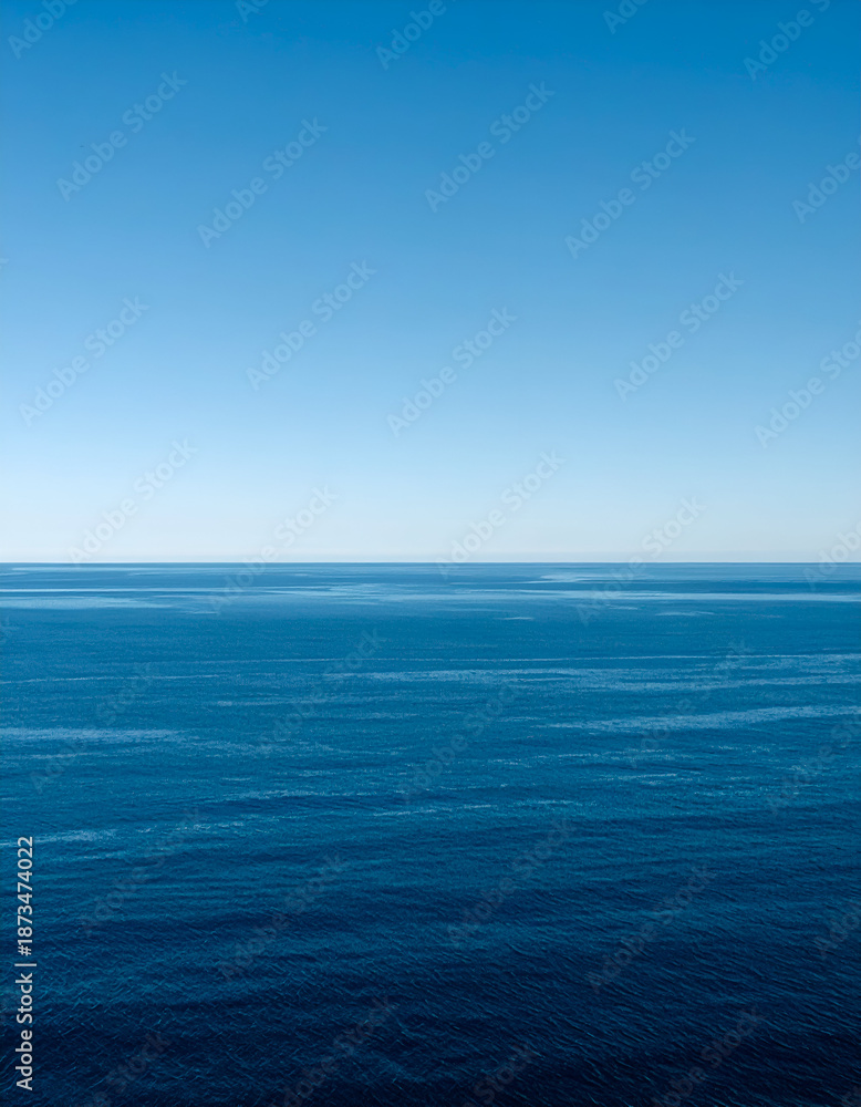 Obraz premium Tranquil seascape with deep blue waters and clear sky, ideal for travel, relaxation, and nature-themed projects.