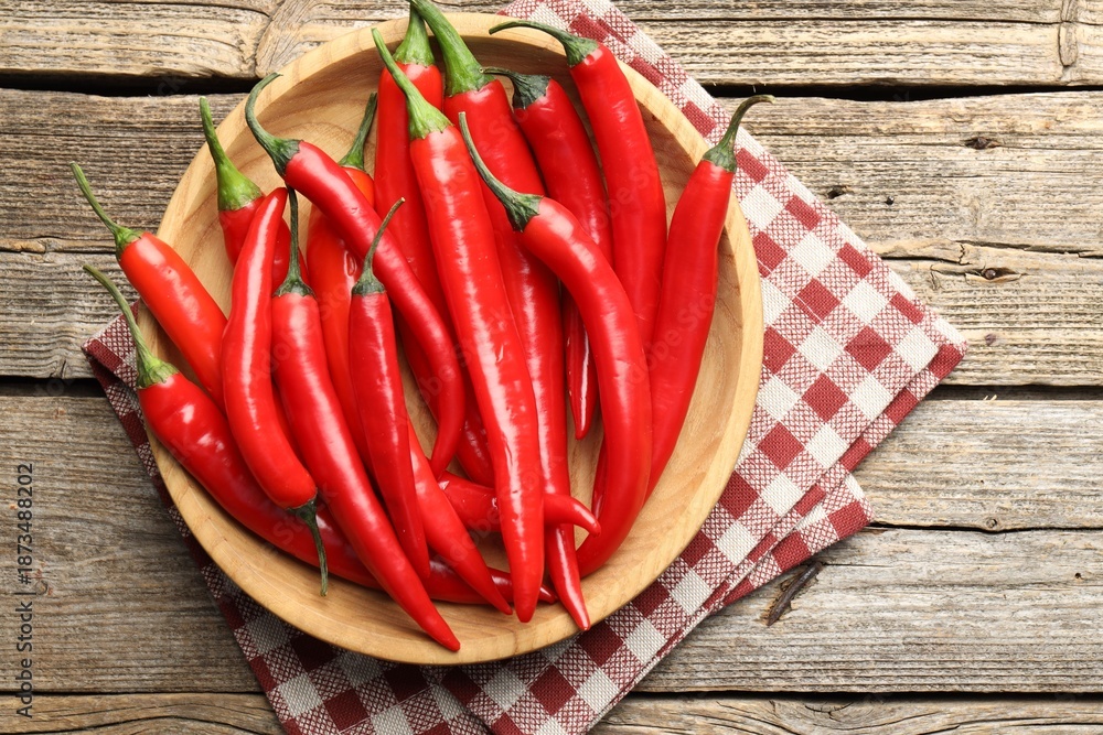 Naklejka premium Ripe red chili peppers on wooden table, top view