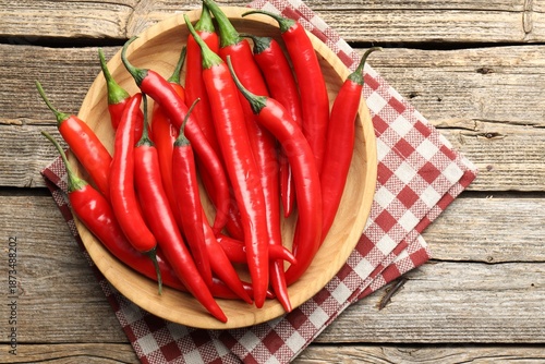 Ripe red chili peppers on wooden table, top view © New Africa