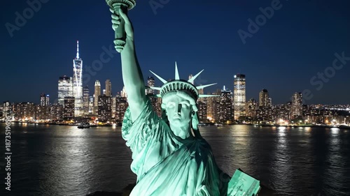 Night View of Statue of Liberty with New York City Skyline.