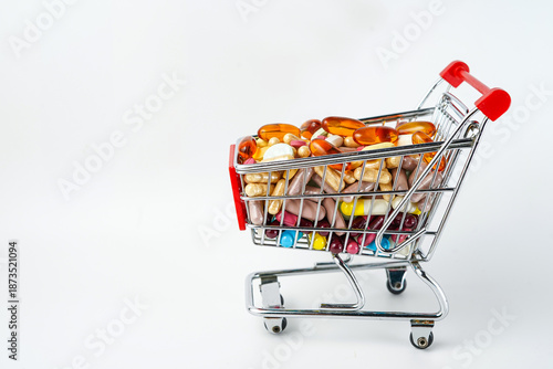 Drug store and online pharmacy concept with supermarket trolley and assorted medicine pills