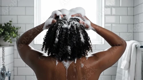 Woman washing hair with shampoo.