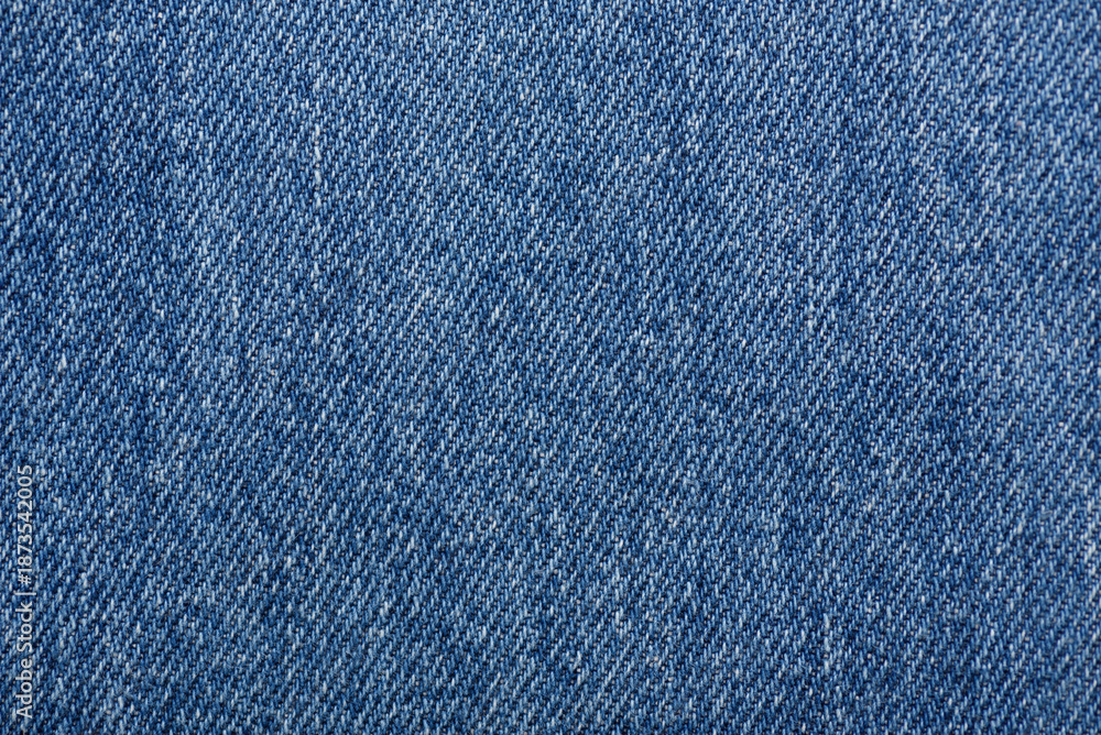 Naklejka premium Washed denim fabric texture background