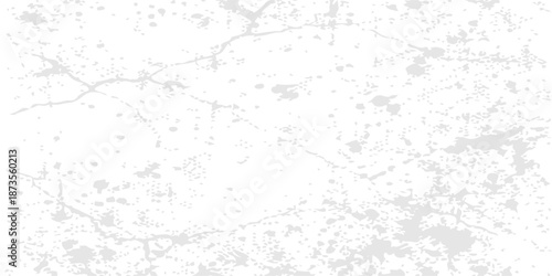 A vintage white grunge wall texture features a rough grey concrete pattern with old cement paint on a dirty stone surface