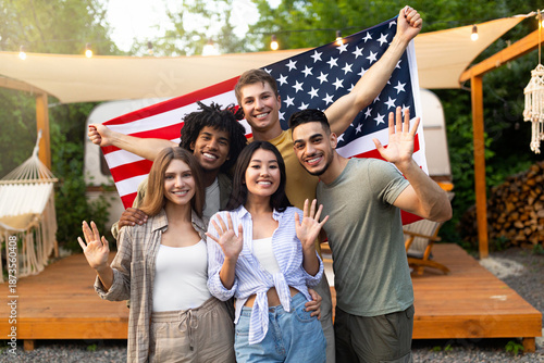 Wallpaper Mural Portrait of multiethnic millennial friends with American flag waving at camera and smiling, posing near RV at camping site. Group of diverse young people celebrating patriotic holiday together outdoor Torontodigital.ca