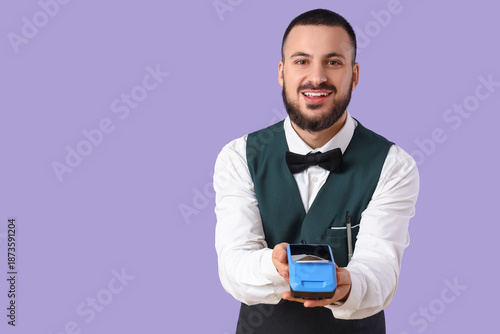 Young waiter with payment t...