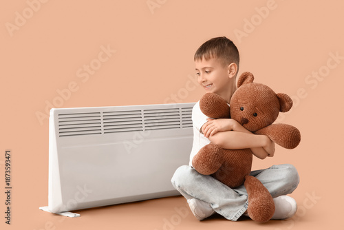 Little boy with toy bear an...